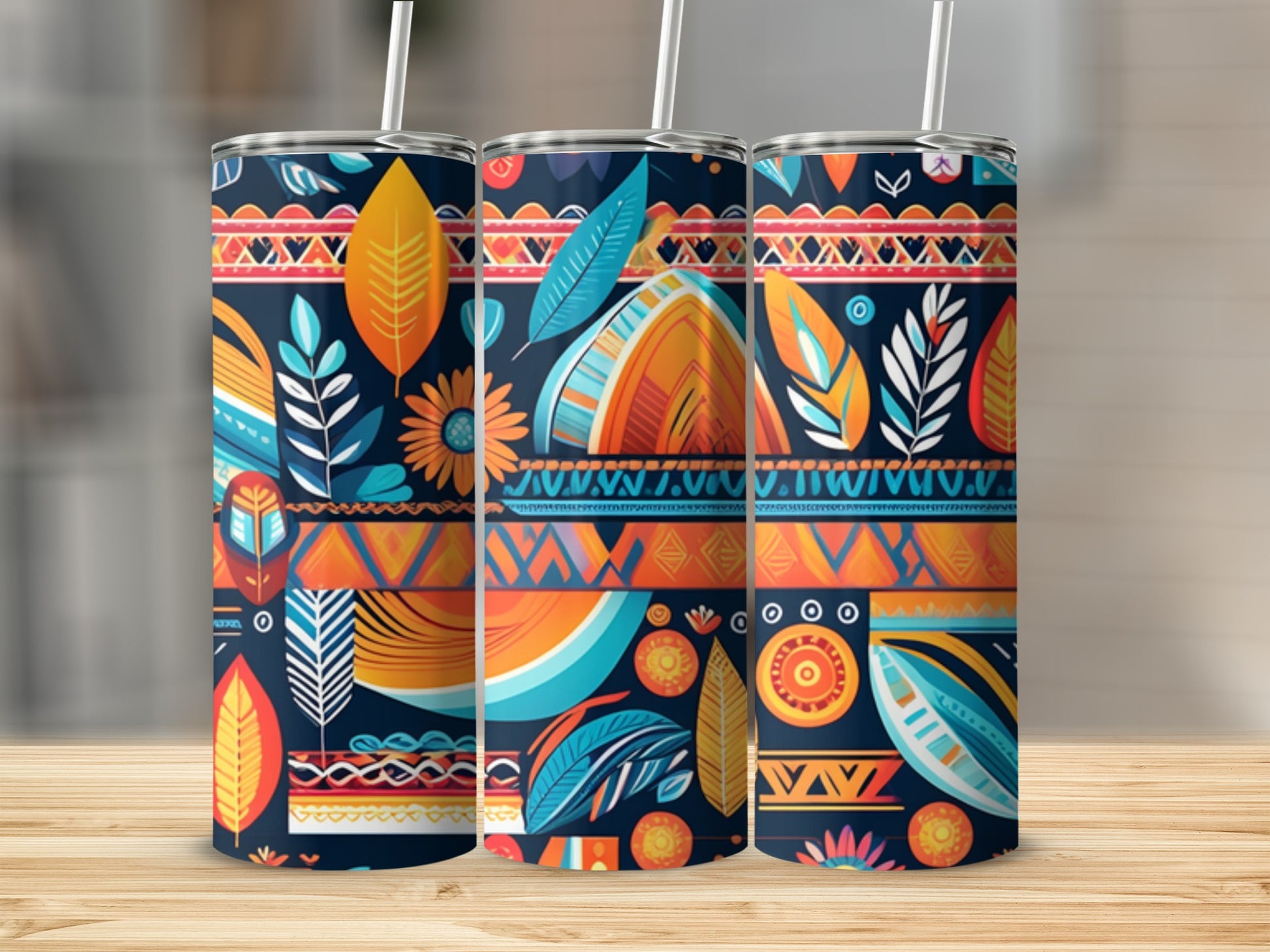 Three tumblers with a tribal-inspired pattern of feathers, leaves, and geometric shapes.