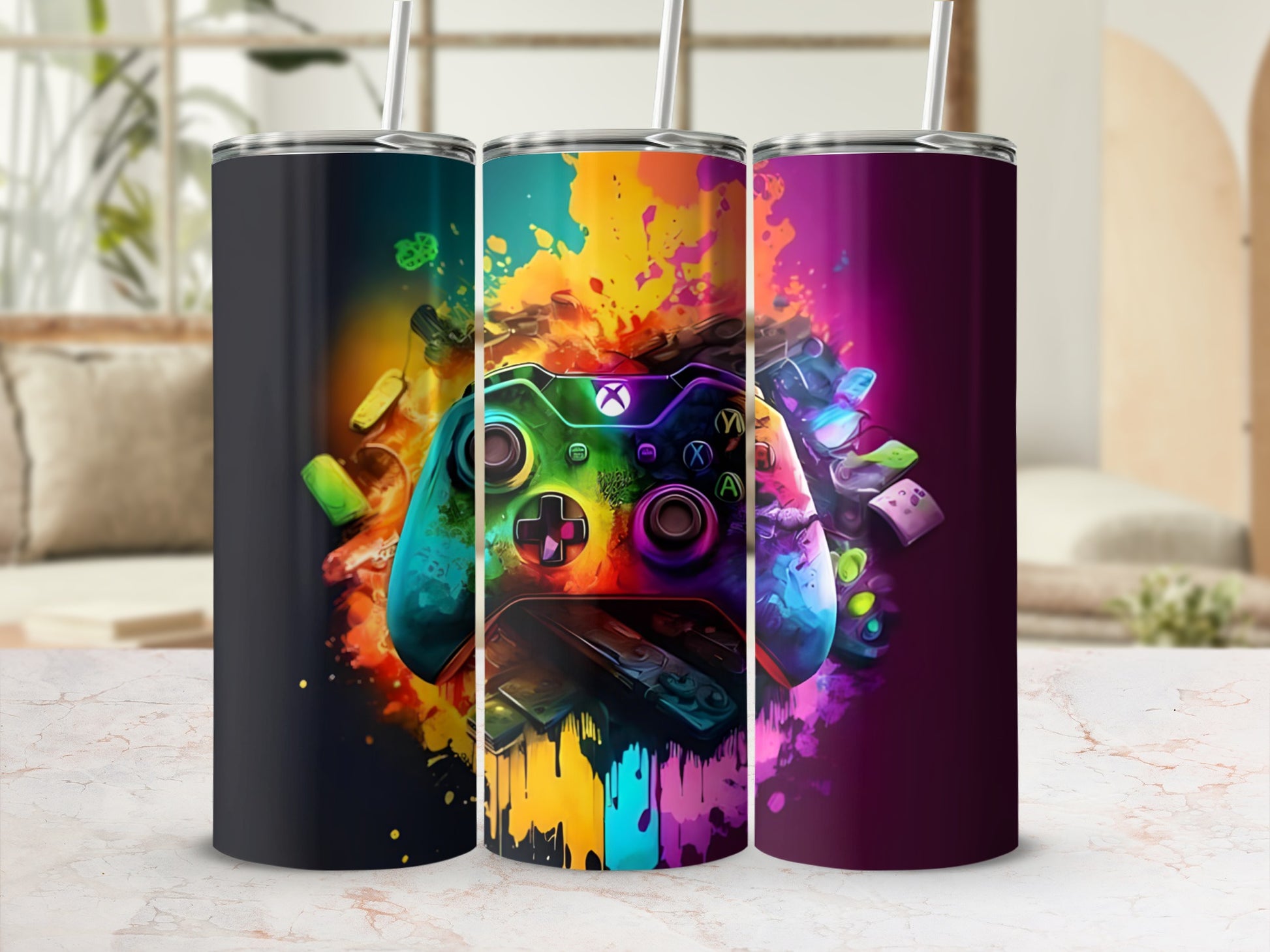 Three colorful tumblers featuring abstract video game controller designs.