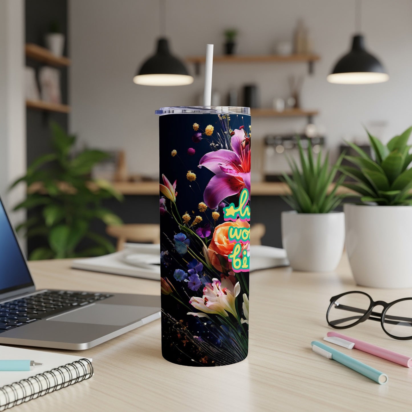 Tall tumbler with colorful floral design and text "Bloom Where You Are Planted".