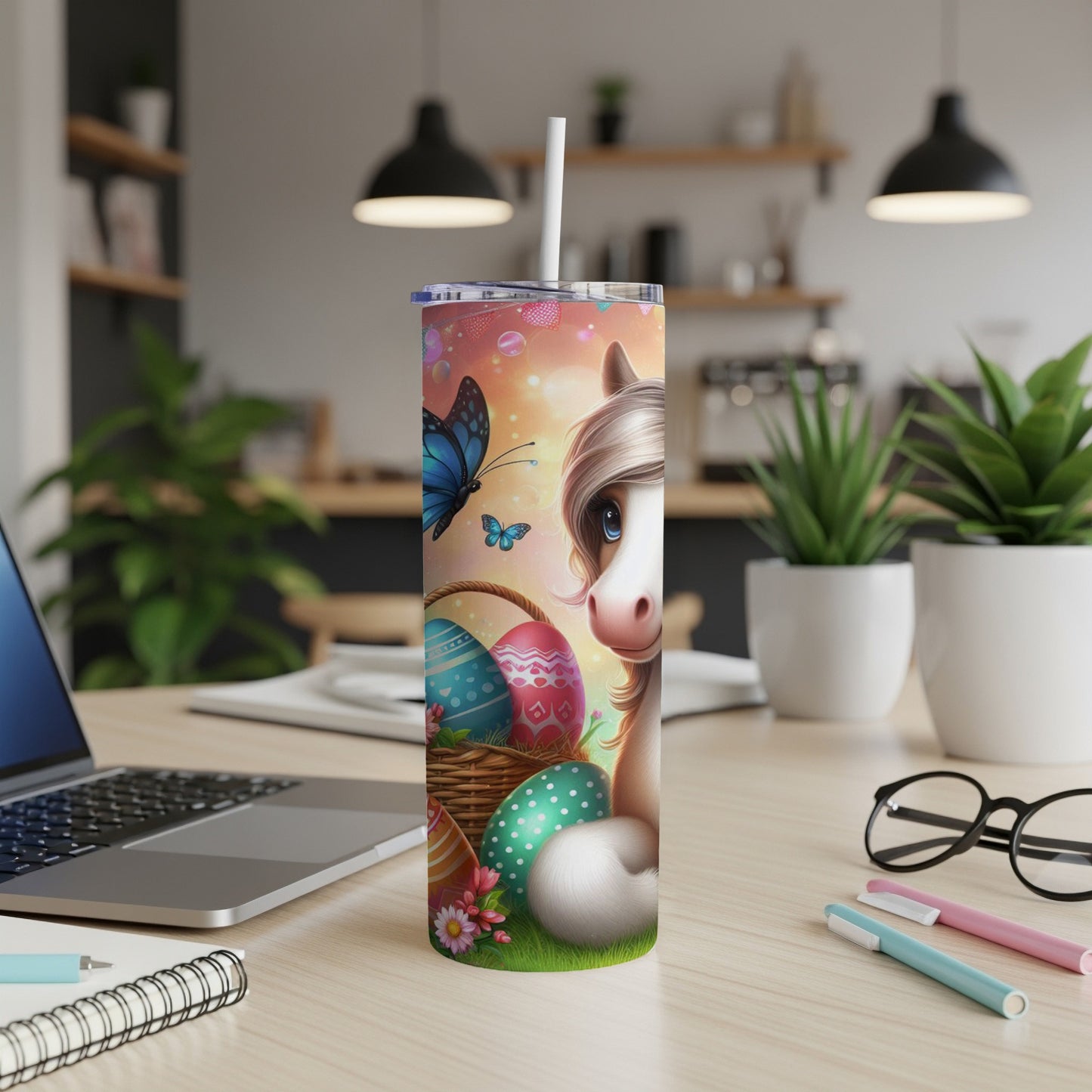 Unicorn with butterfly and Easter eggs on a desktop.