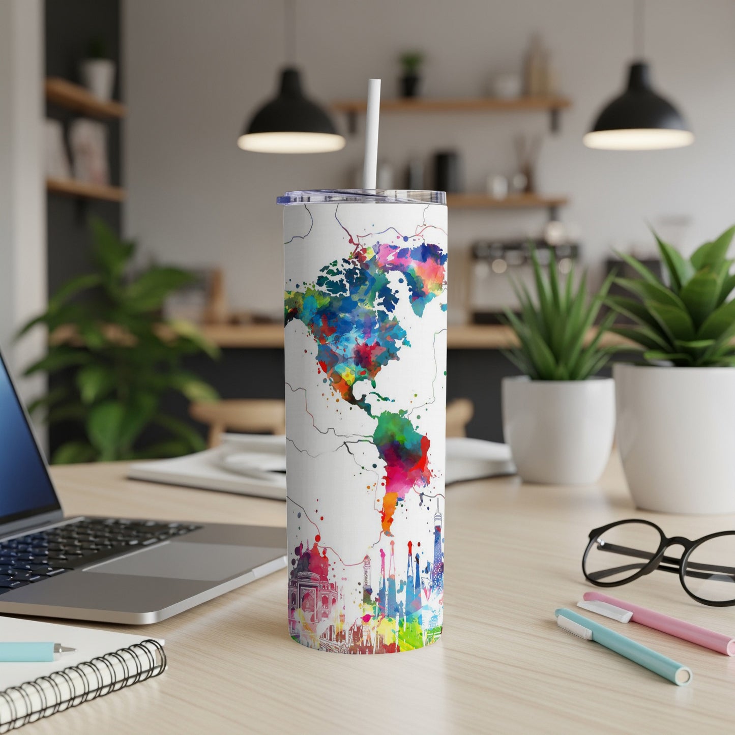 White tumbler with watercolor map of Americas and city skylines.