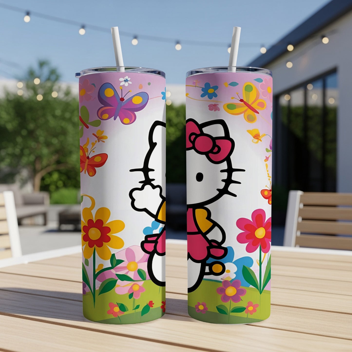 Two tumblers with Hello Kitty, butterflies, and flowers on a table.