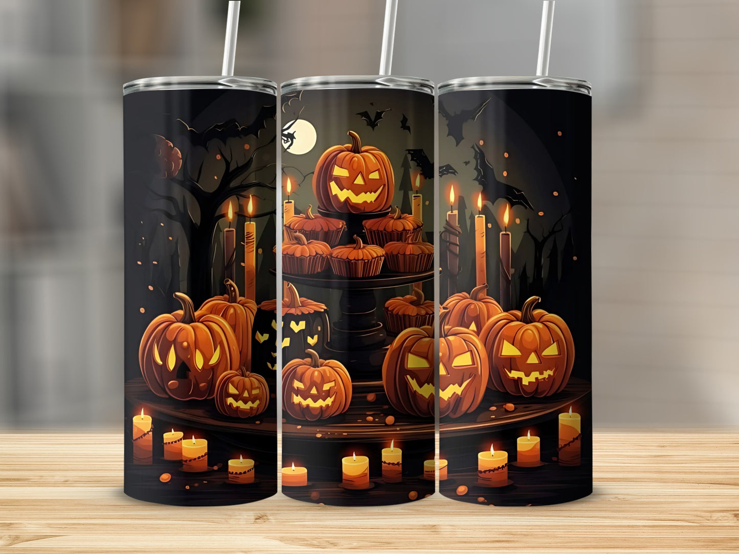 Three tumblers with a Halloween design featuring carved pumpkins and candles.