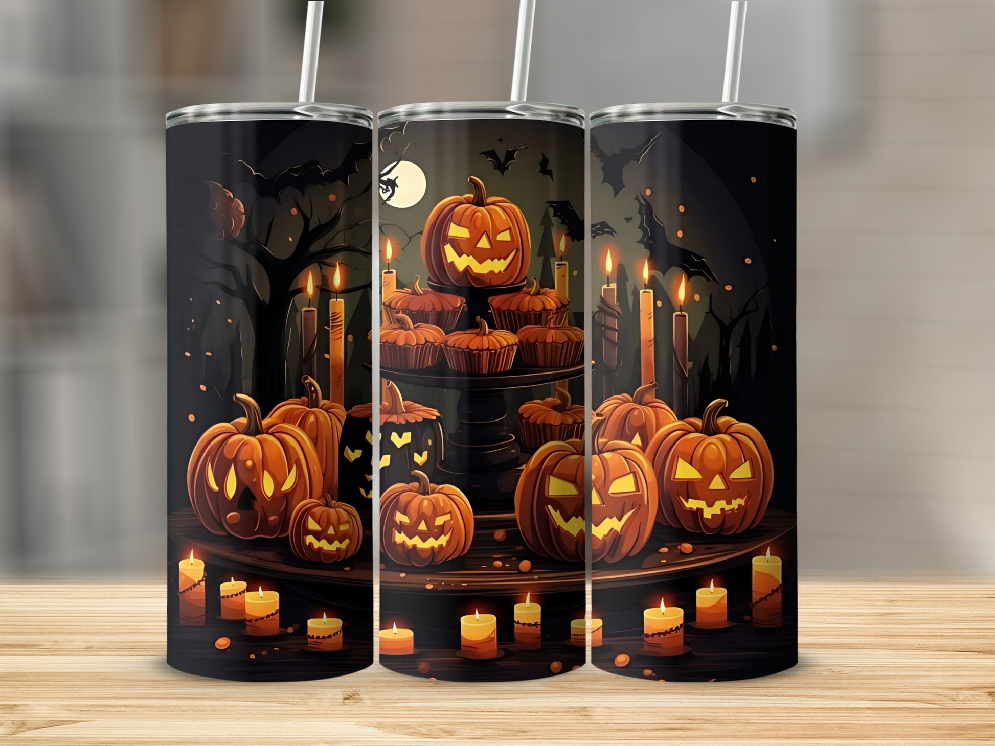 Three tumblers with a Halloween design featuring carved pumpkins and candles.