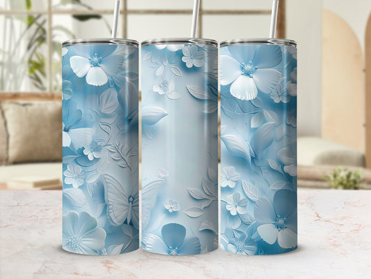 Three blue tumblers with raised floral and butterfly designs.