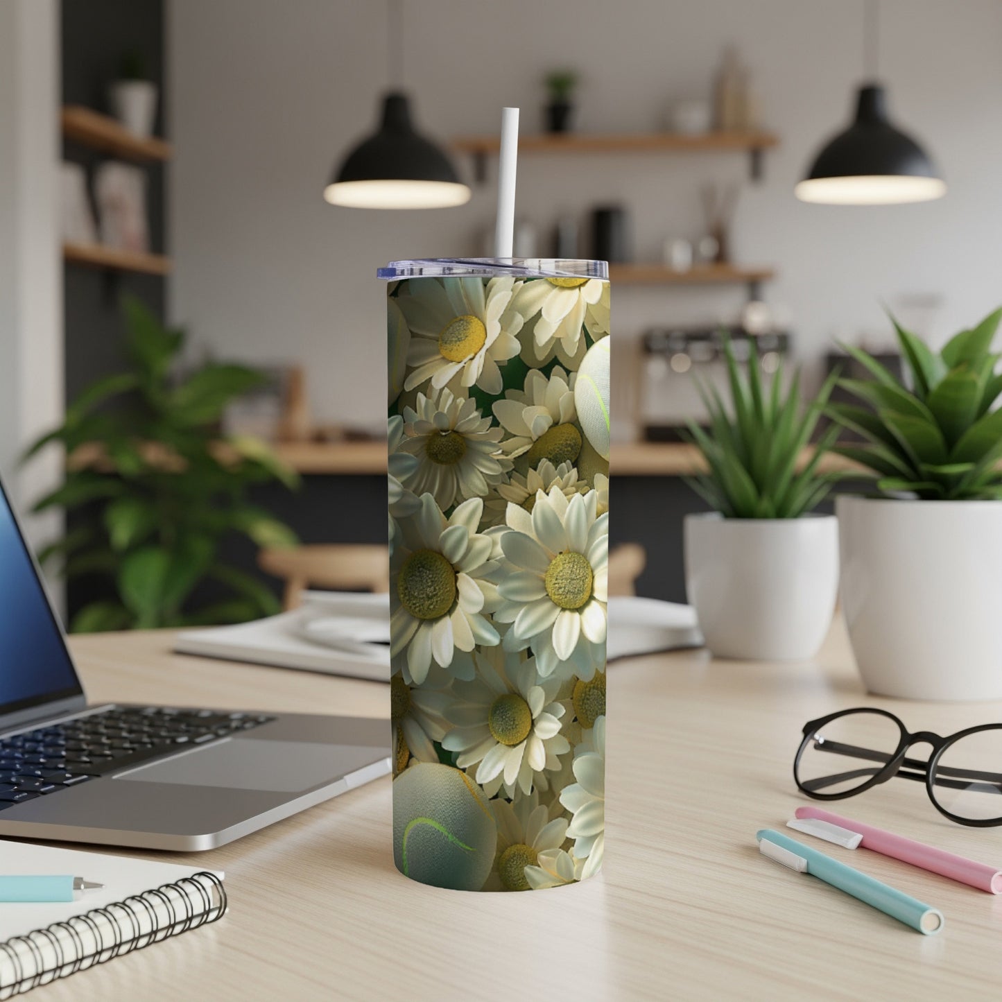 White daisy and tennis ball pattern on a white tumbler.