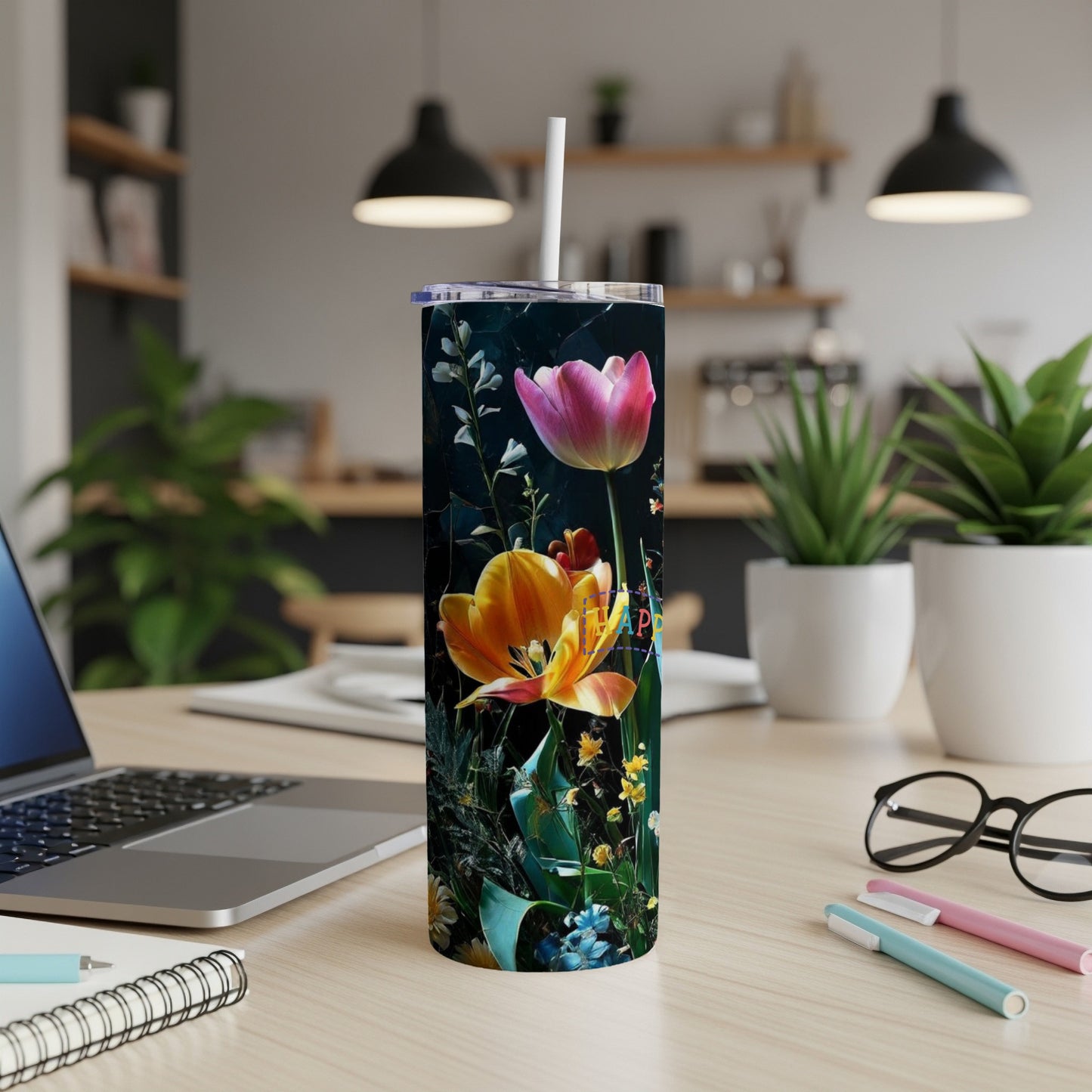 Tall tumbler with bright pink and orange tulips against dark floral background.