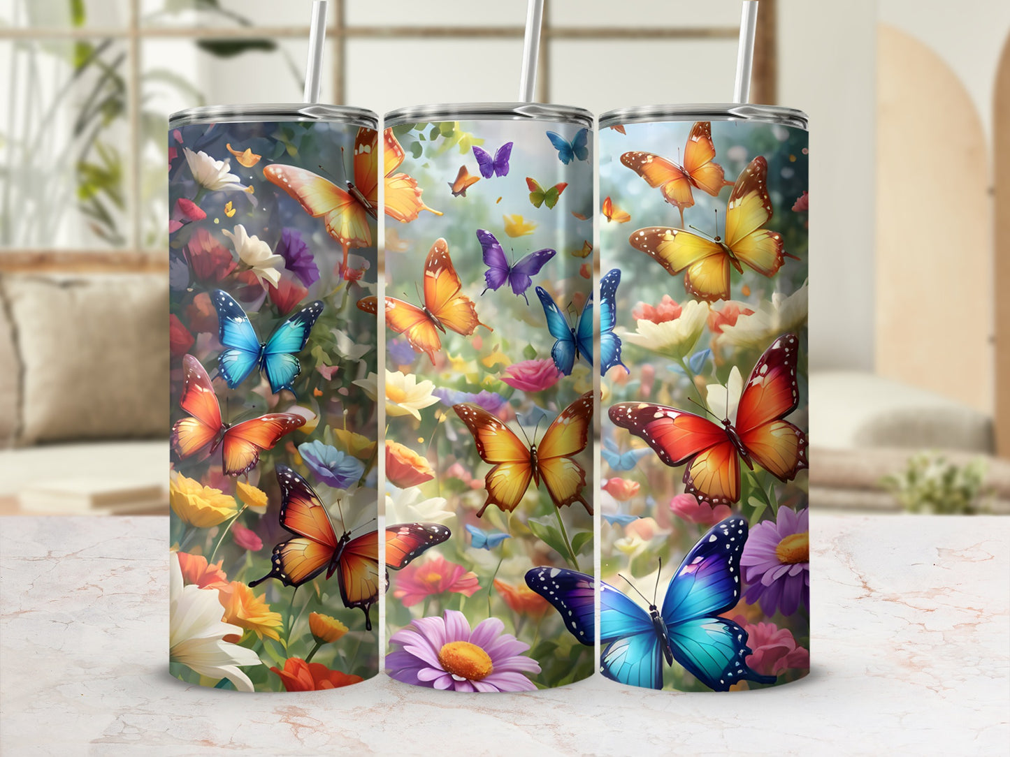 Three tumblers with colorful butterflies and flowers.