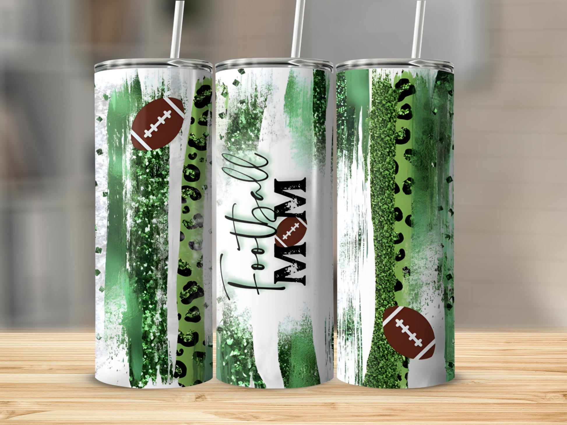 Football Mom tumbler with green paint strokes and leopard print.