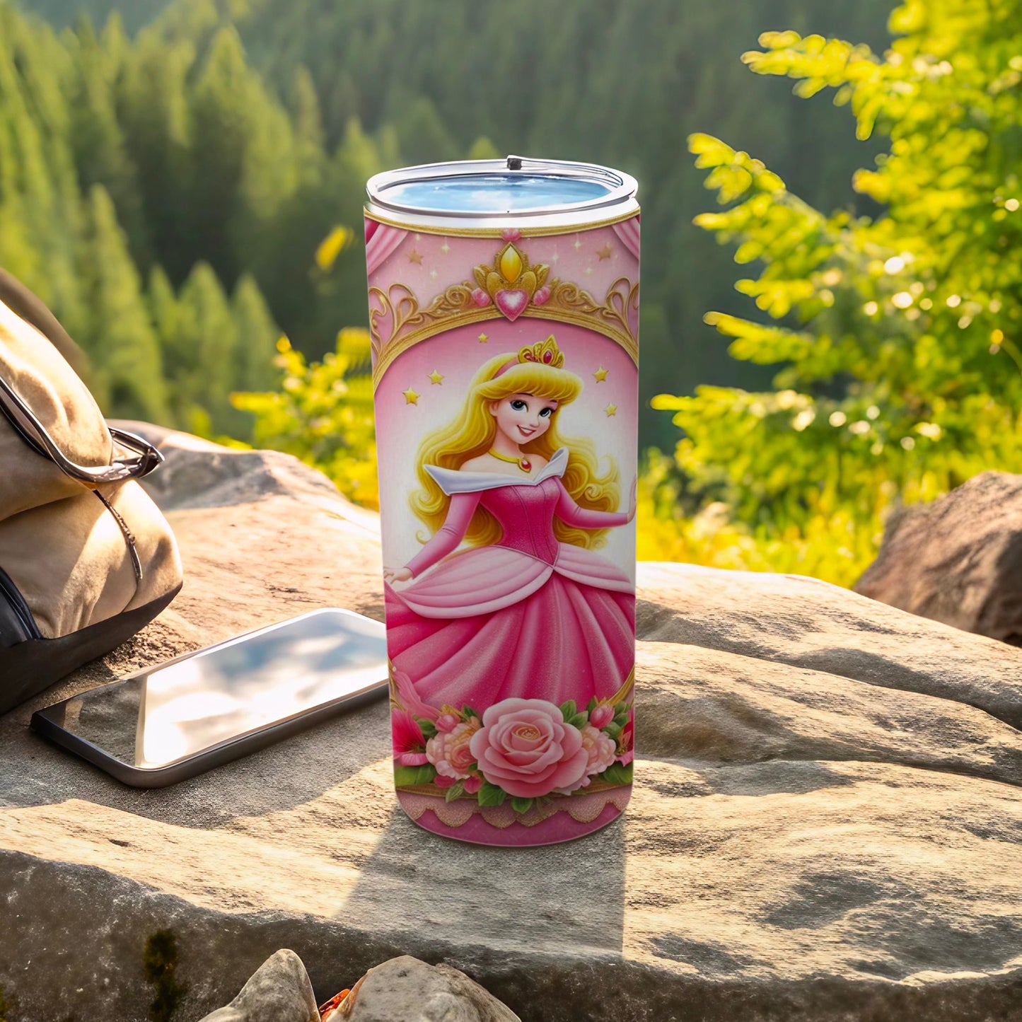 Pink princess tumbler with crown and roses, with phone and backpack outdoors.