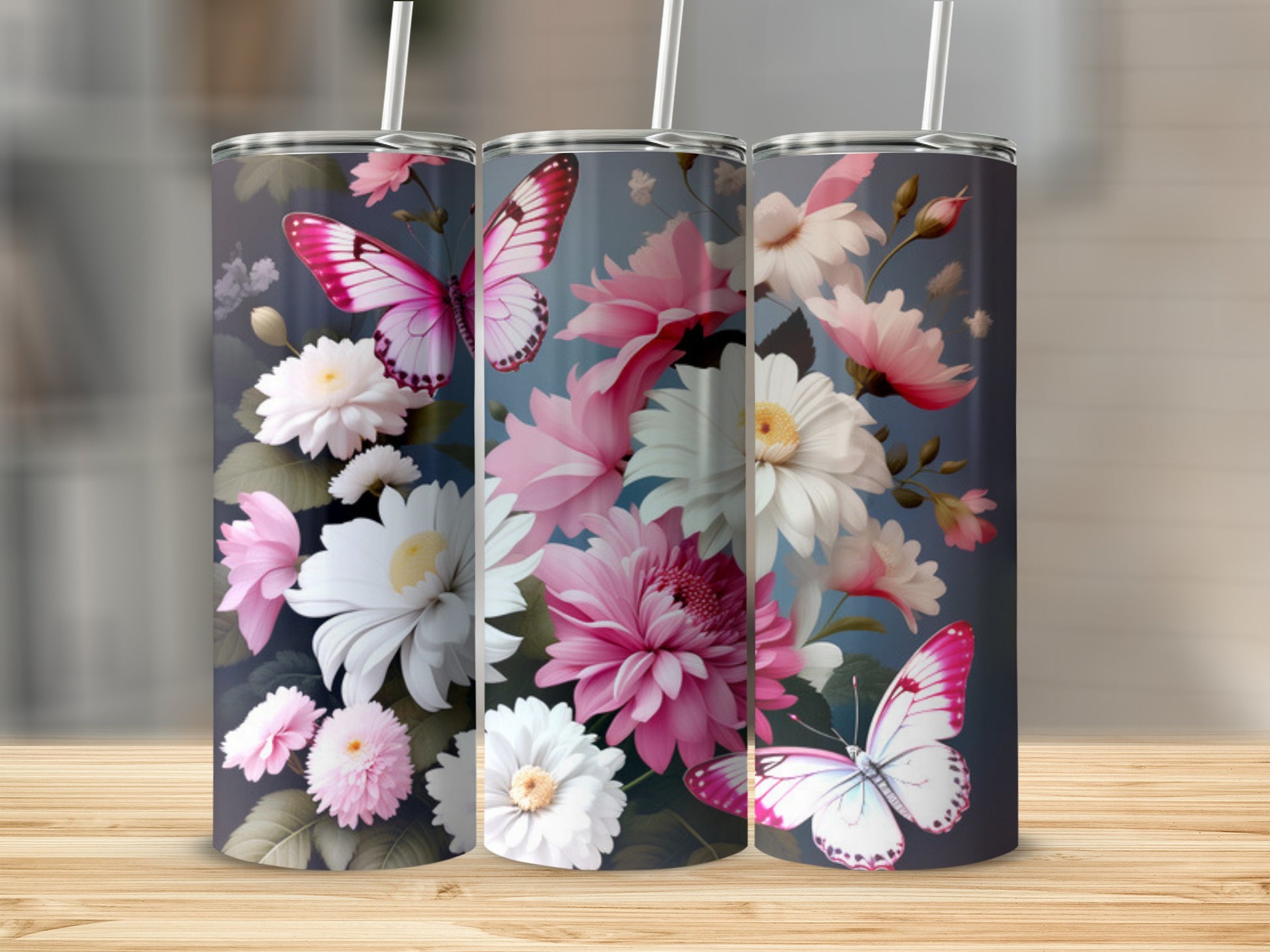 Floral and butterfly design on a set of three tall tumblers.