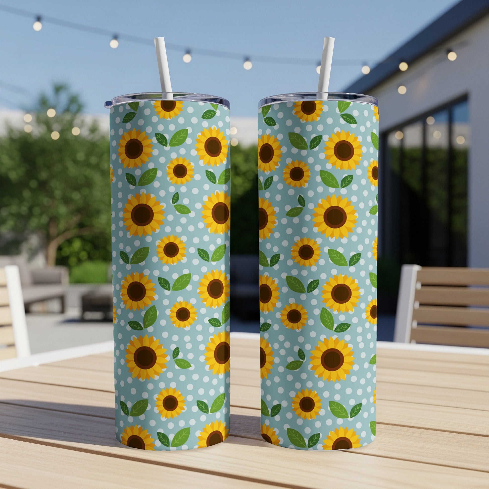 Two tall tumblers with a light blue polka dot pattern and yellow sunflowers.