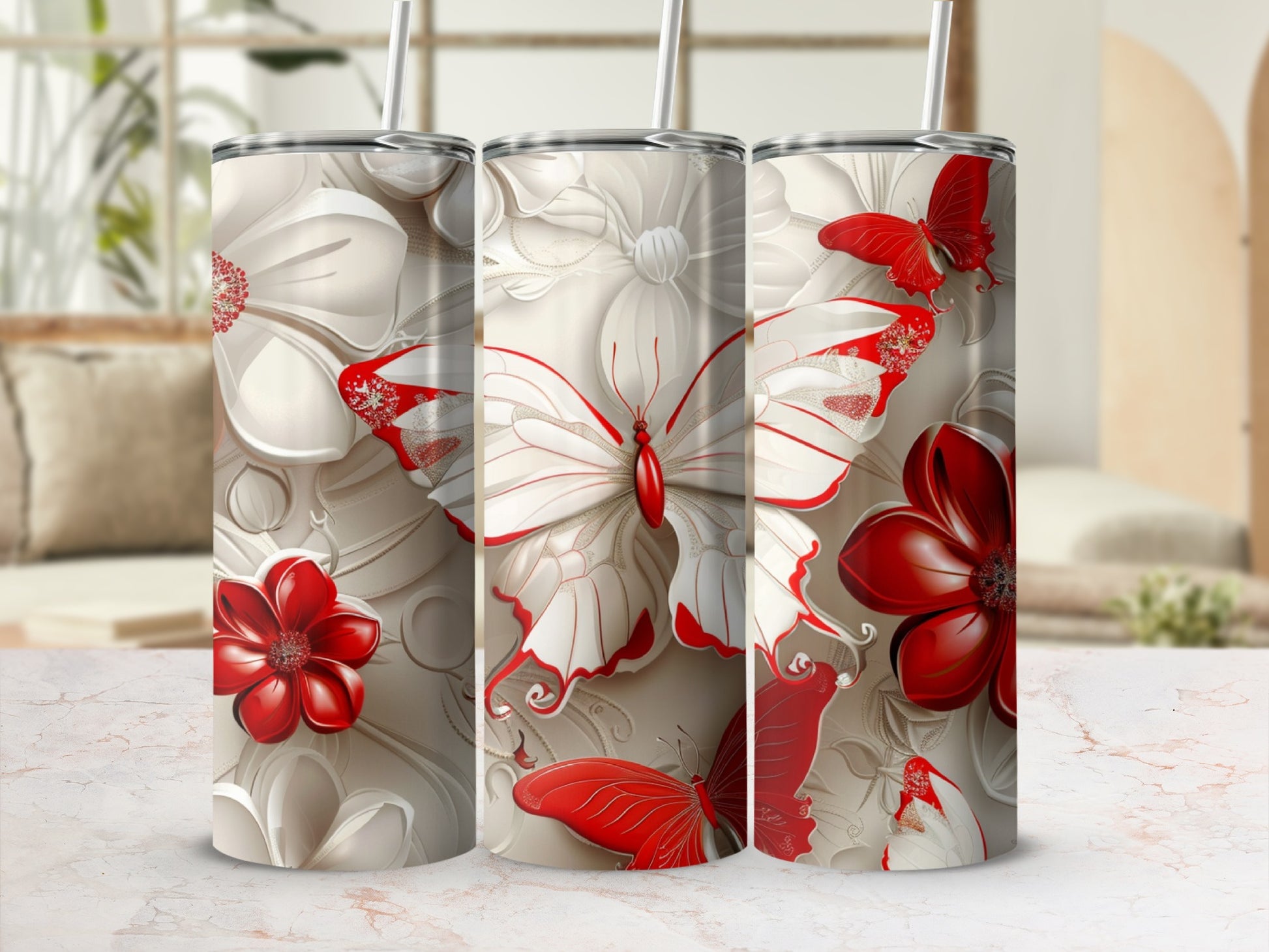 Three tumblers with a red and white butterfly and floral design.