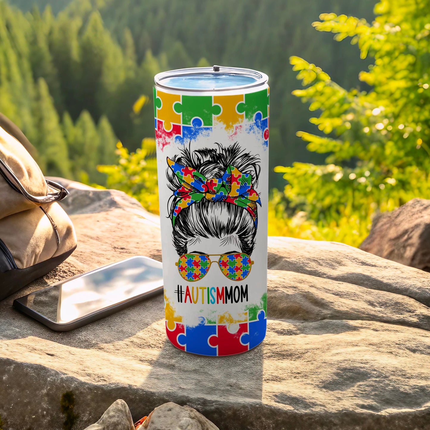 Autism Mom tumbler with puzzle piece pattern and sunglasses.