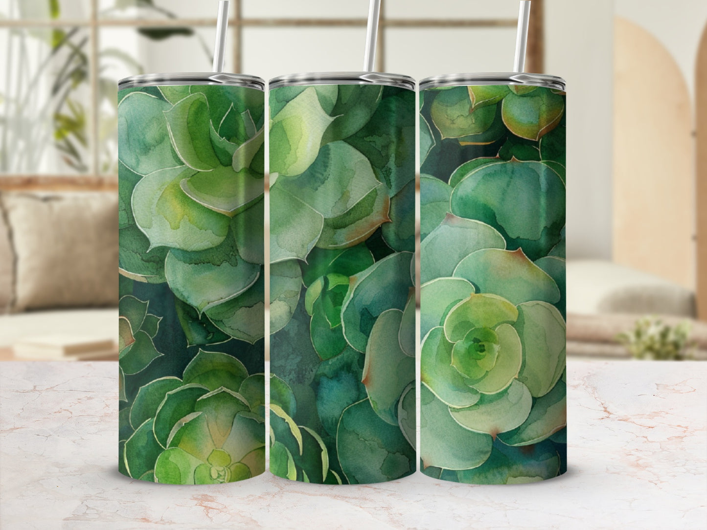 Succulent plant pattern on three identical tumblers with straws, displayed on a marble surface.