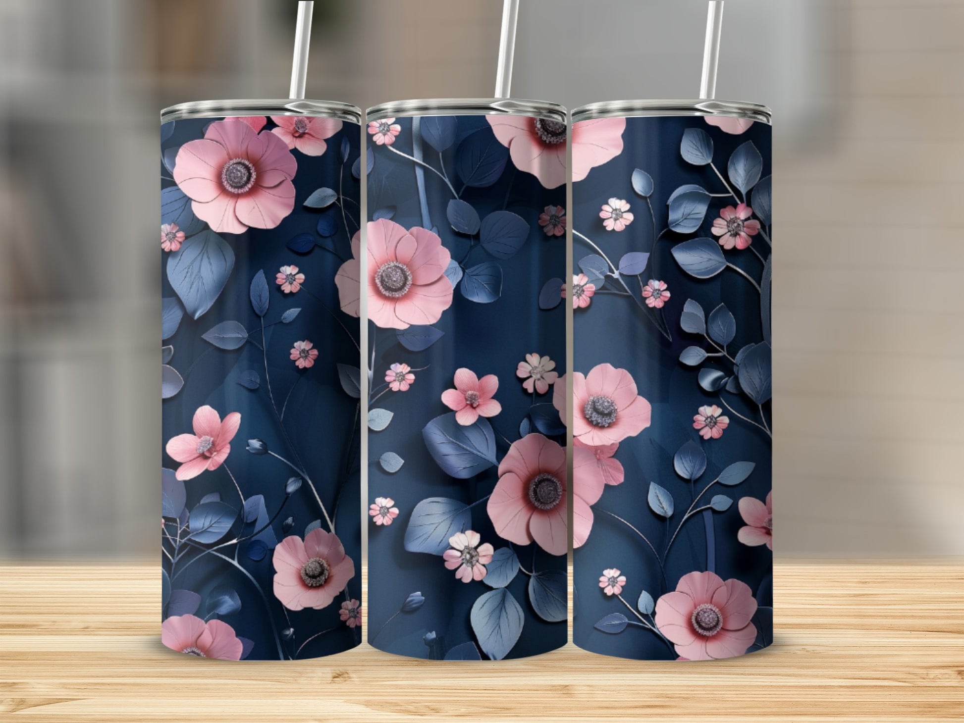 Three dark blue tumblers with pink floral and leaf pattern.
