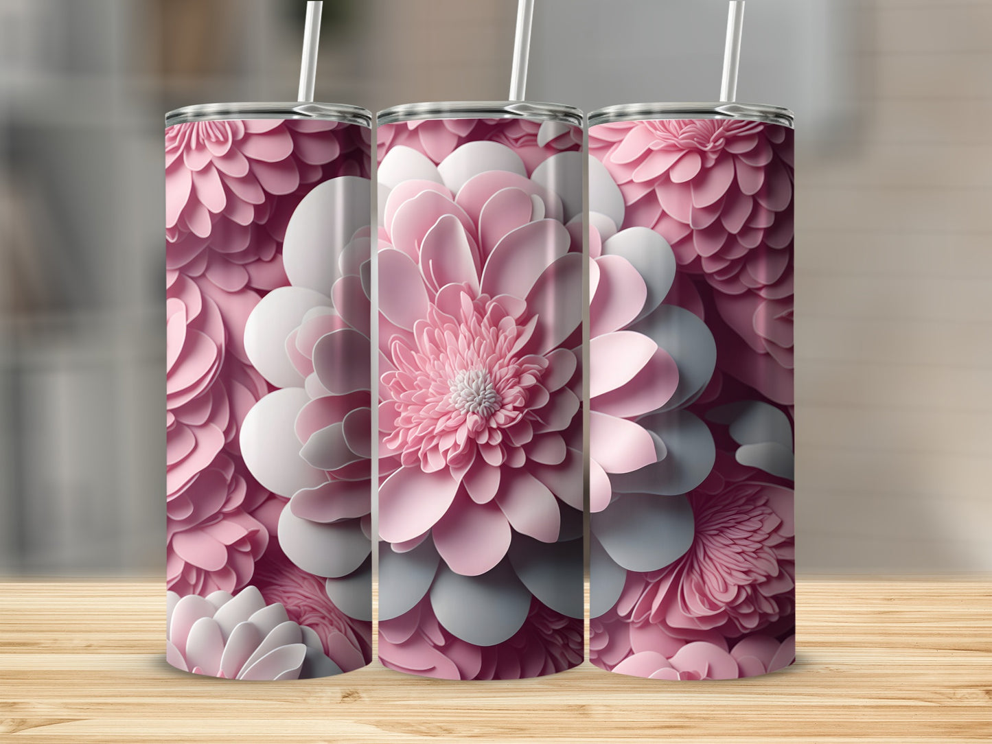 Three pink and white floral patterned tumblers on a wooden surface.
