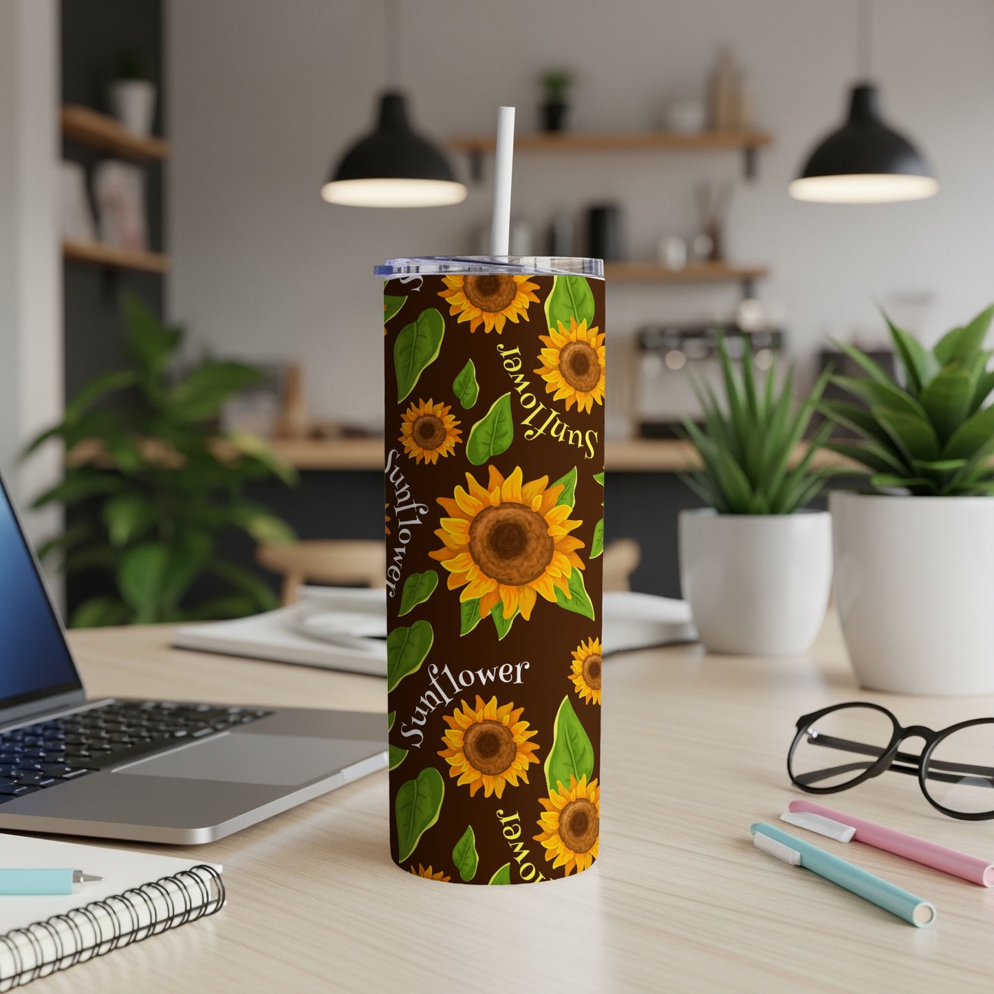 Tumbler with brown background and repeating sunflower and leaf pattern.