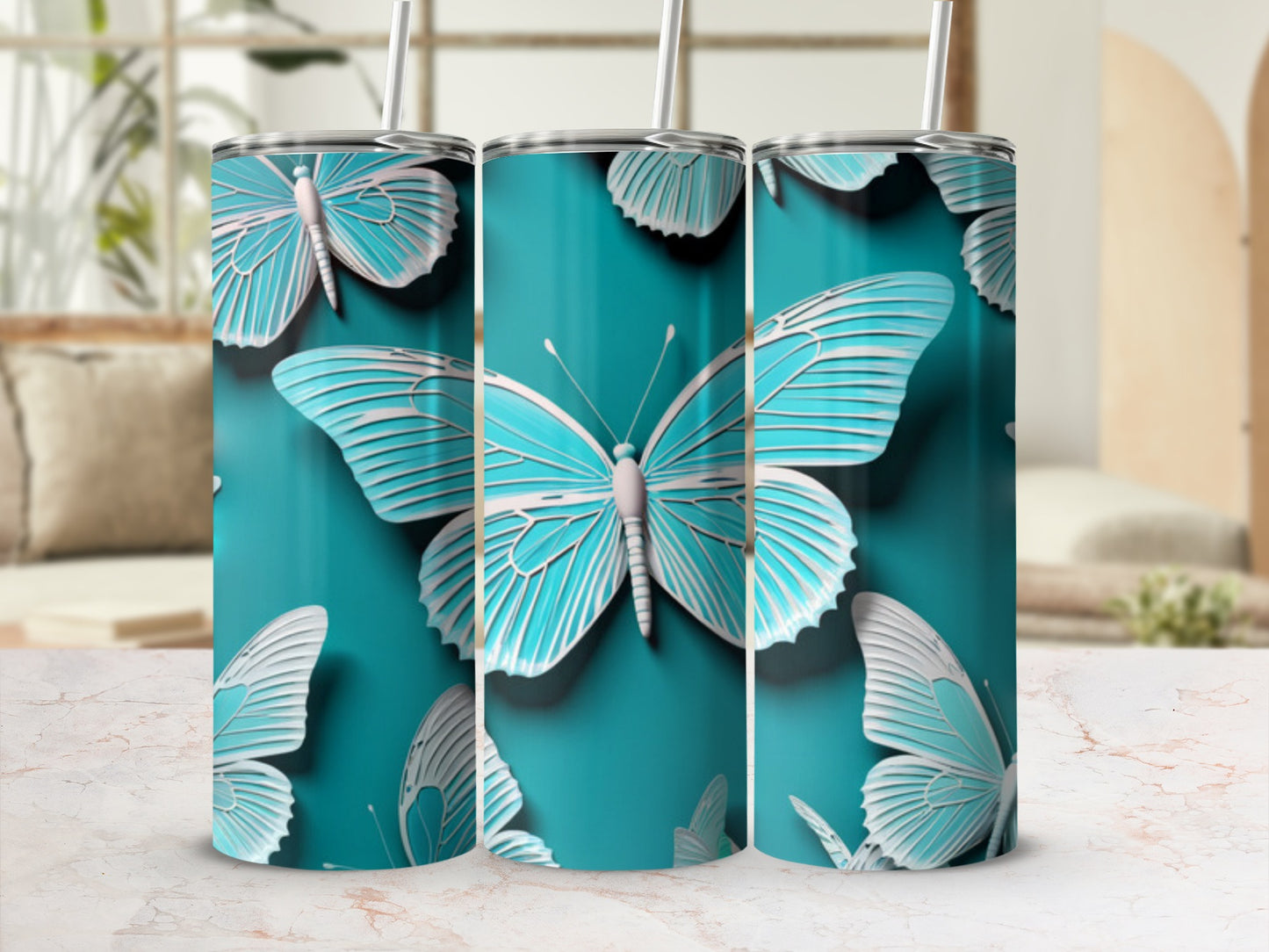 Three teal tumblers with detailed white butterfly patterns.