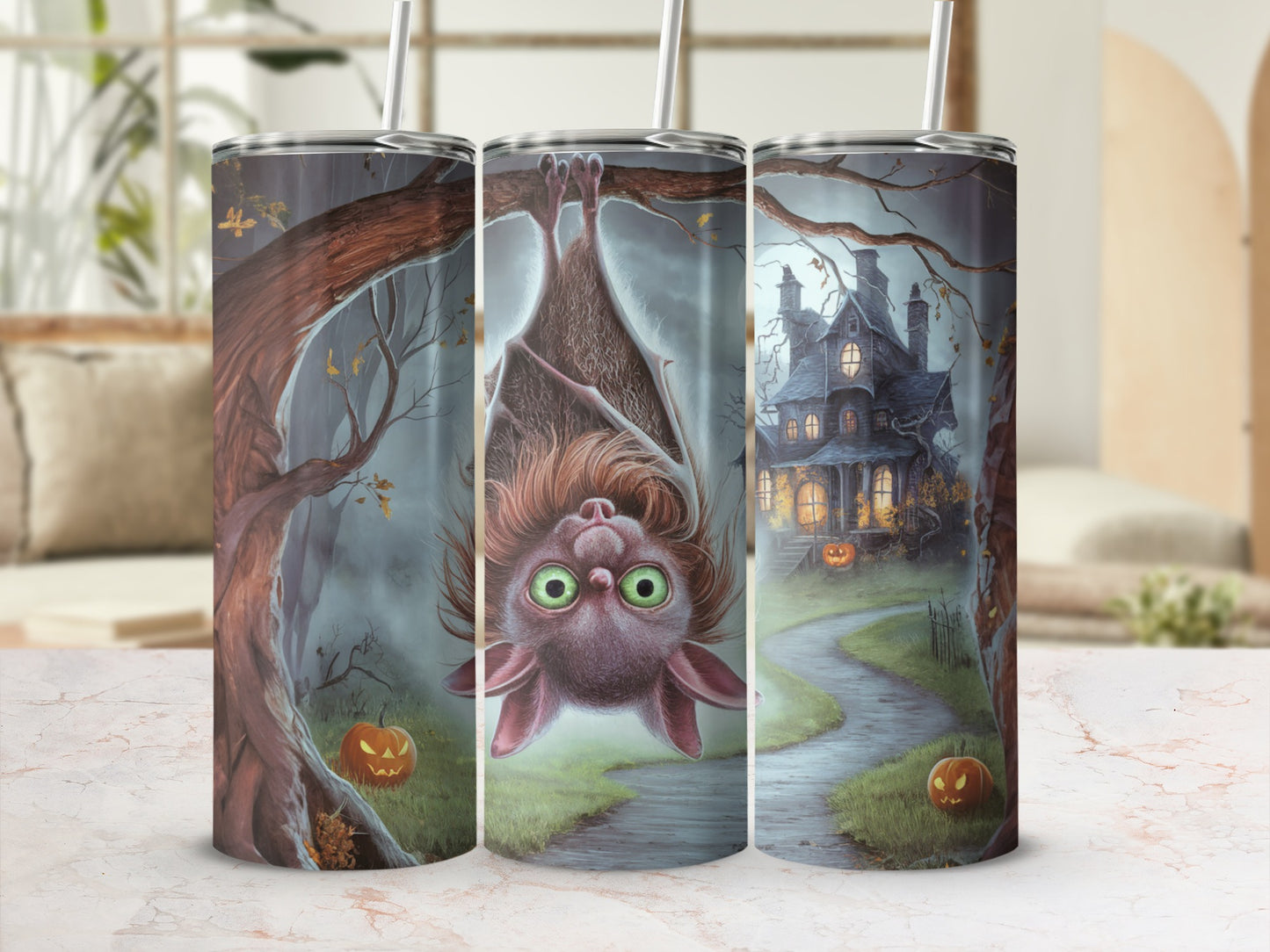 Halloween tumbler with a bat, spooky house, and pumpkins.