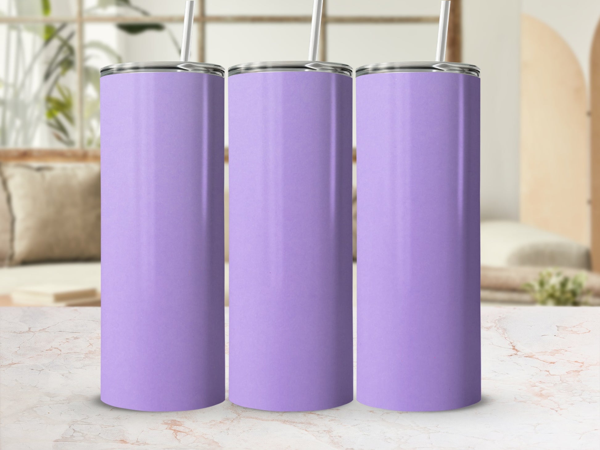 Three plain purple tumblers with straws stand in a row.
