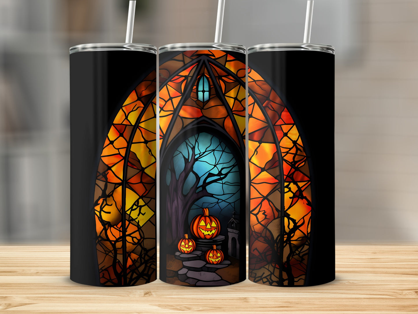 Three tumblers featuring a stained-glass arch with pumpkins and a spooky tree.