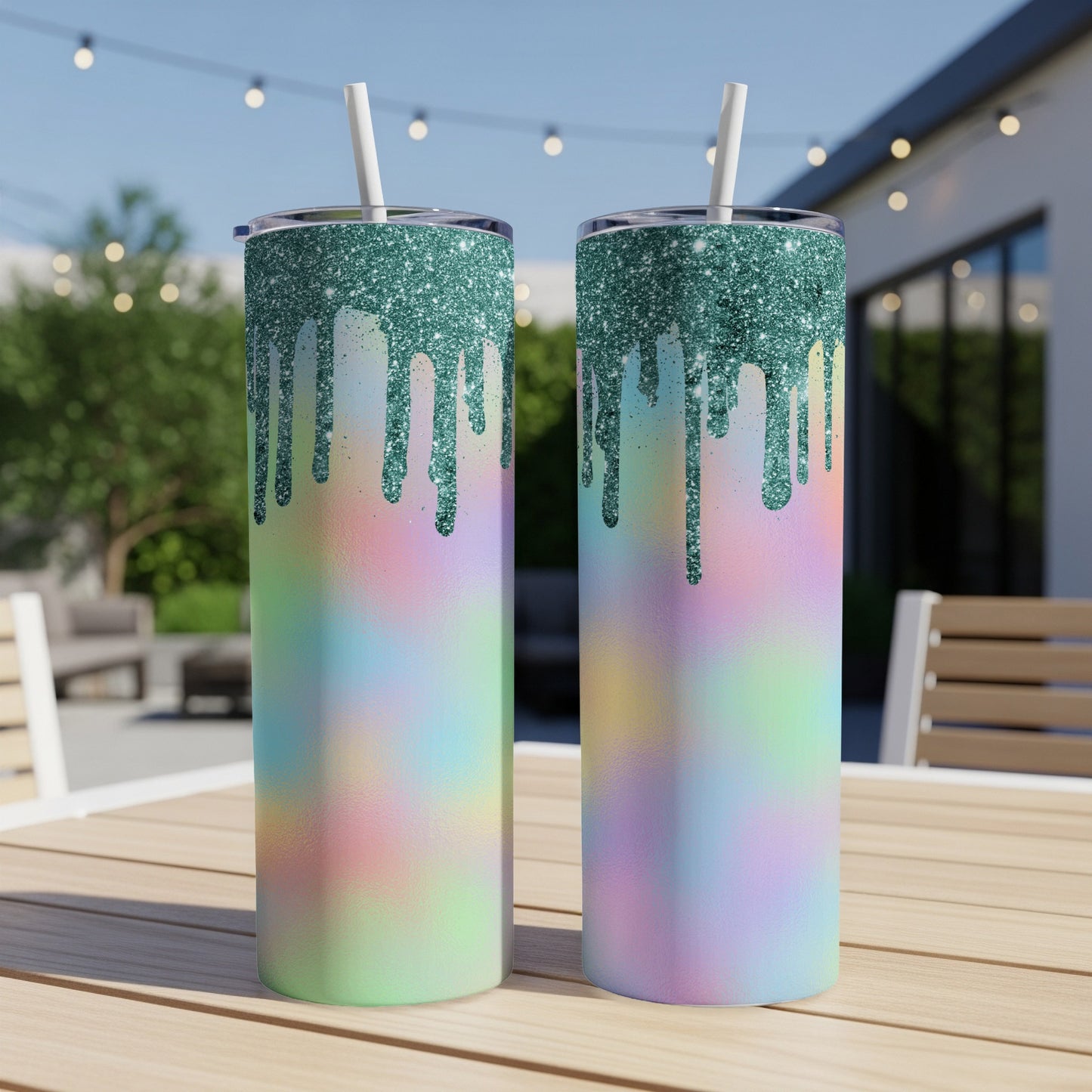 Two glitter drip tumblers with pastel tie-dye design on a table.