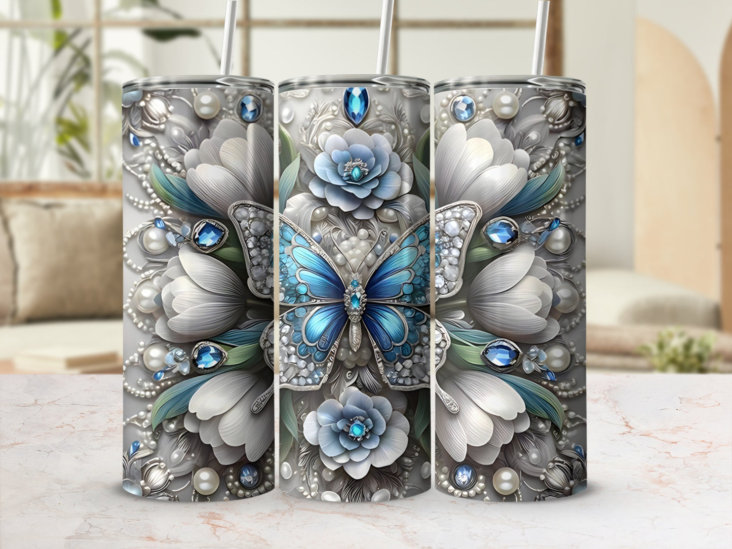 Three tumblers with a blue butterfly and ornate floral embellishments.