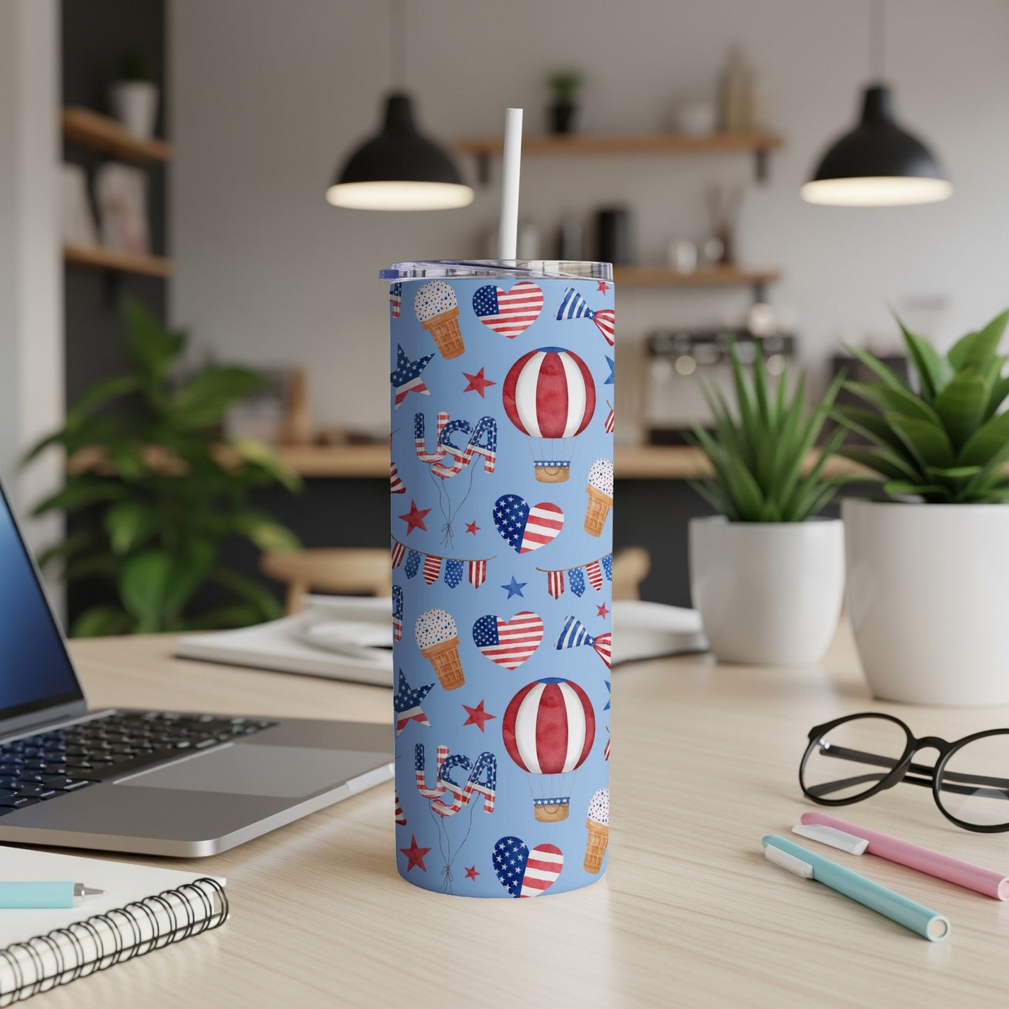 Blue tumbler with red, white, and blue patriotic pattern of hot air balloons and flags.