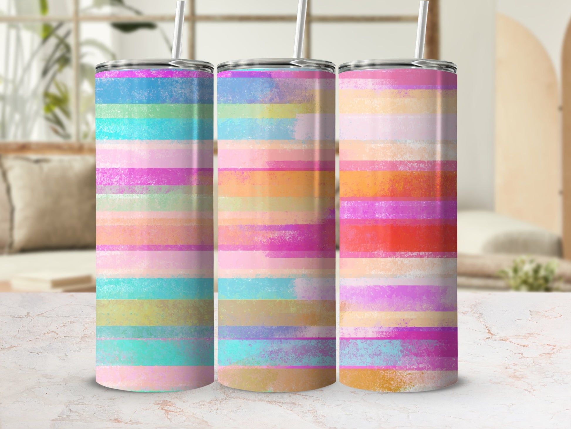 Three tumblers with pastel horizontal stripes and straws.