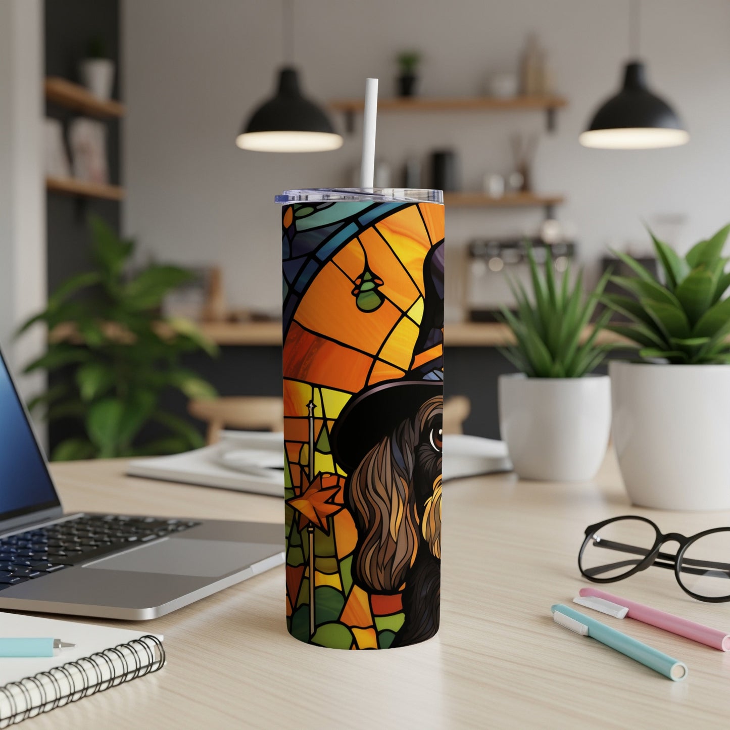 Stained glass style dog wearing a witch hat on a tumbler with a straw.