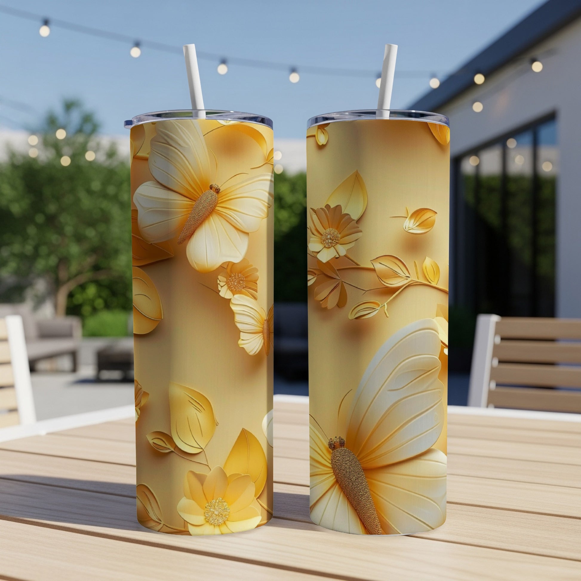 Two golden tumblers with butterfly and floral embossed designs.