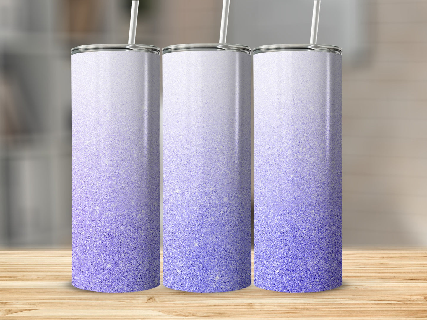 Three tall tumblers with a purple glitter ombre design and straw.