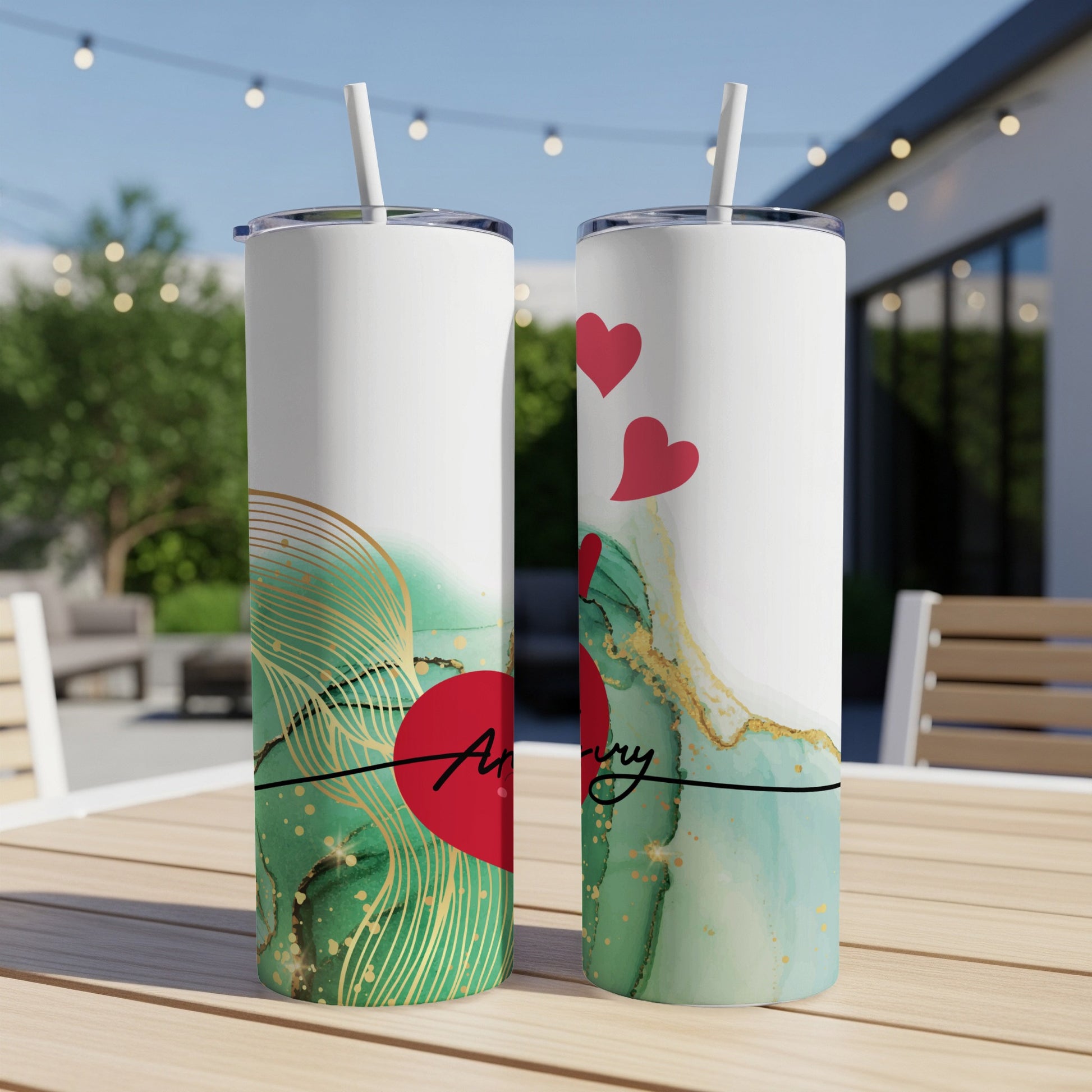 Two tumblers with a red heart and "Anniversary" text on a green marble background.