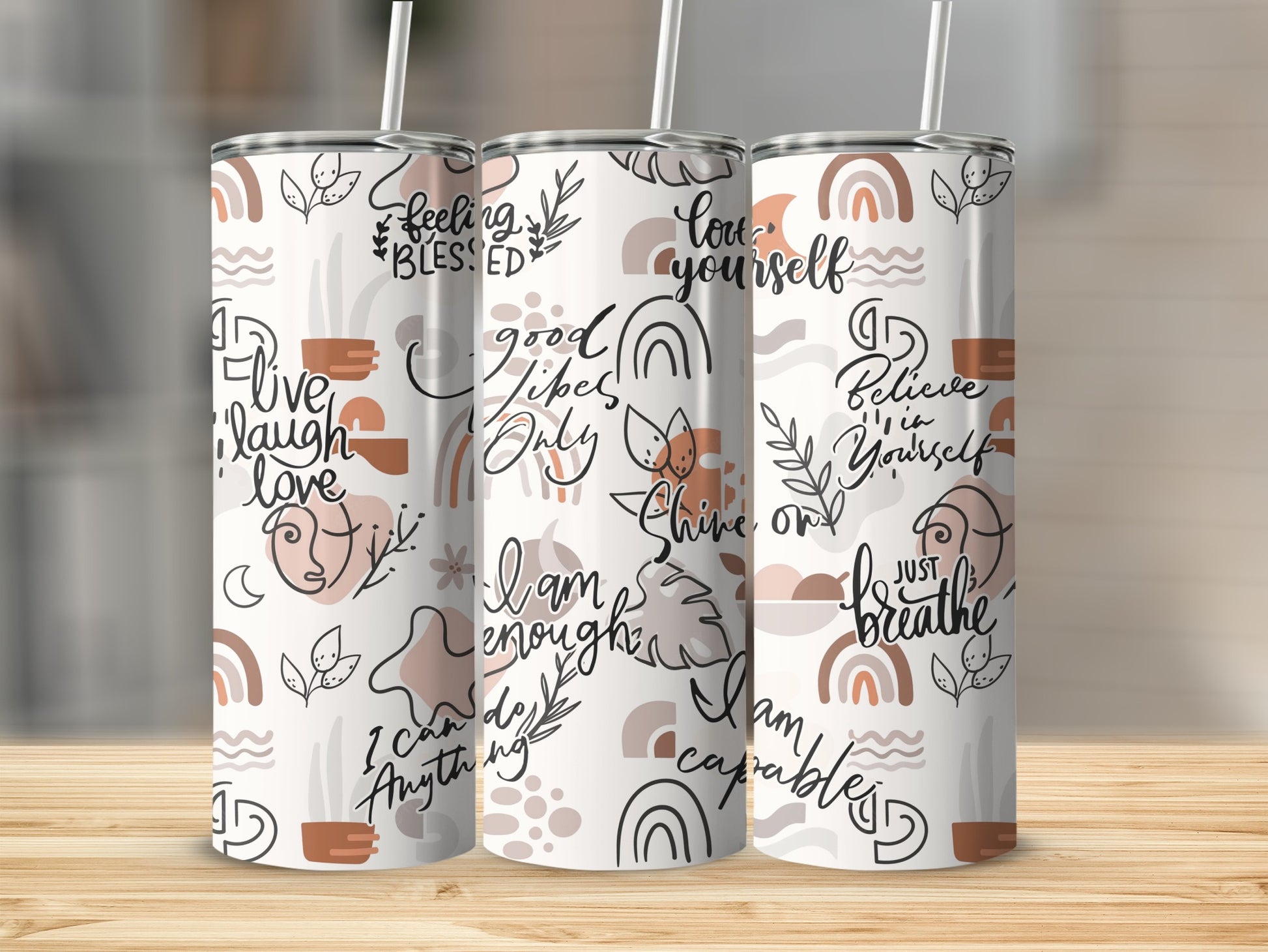 Three tumblers with abstract shapes and inspirational text designs.