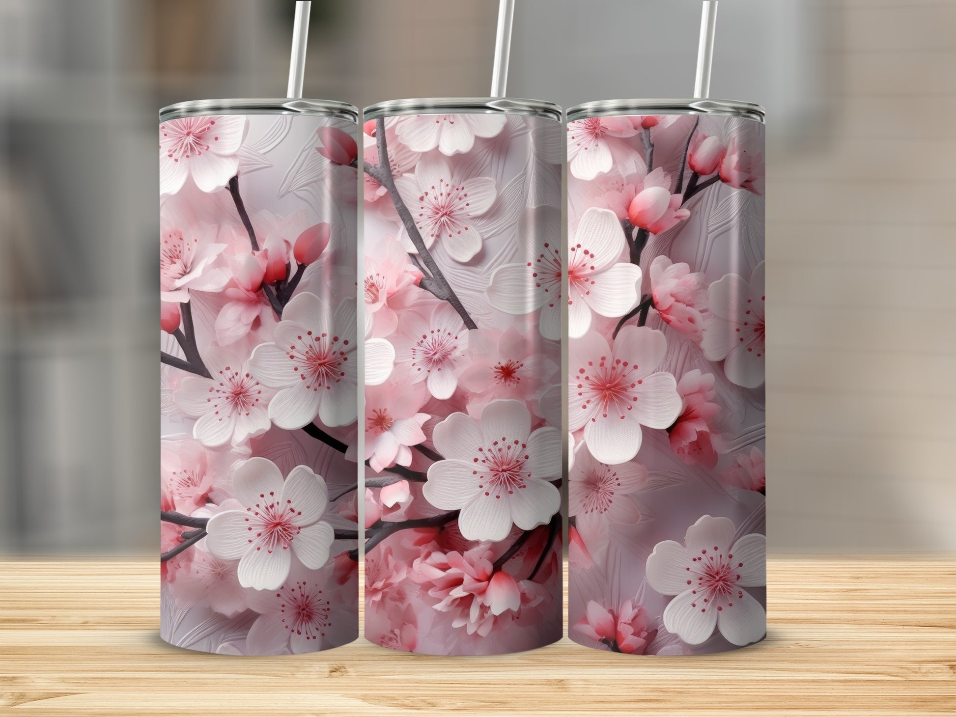 Three tumblers with a pink cherry blossom floral design.
