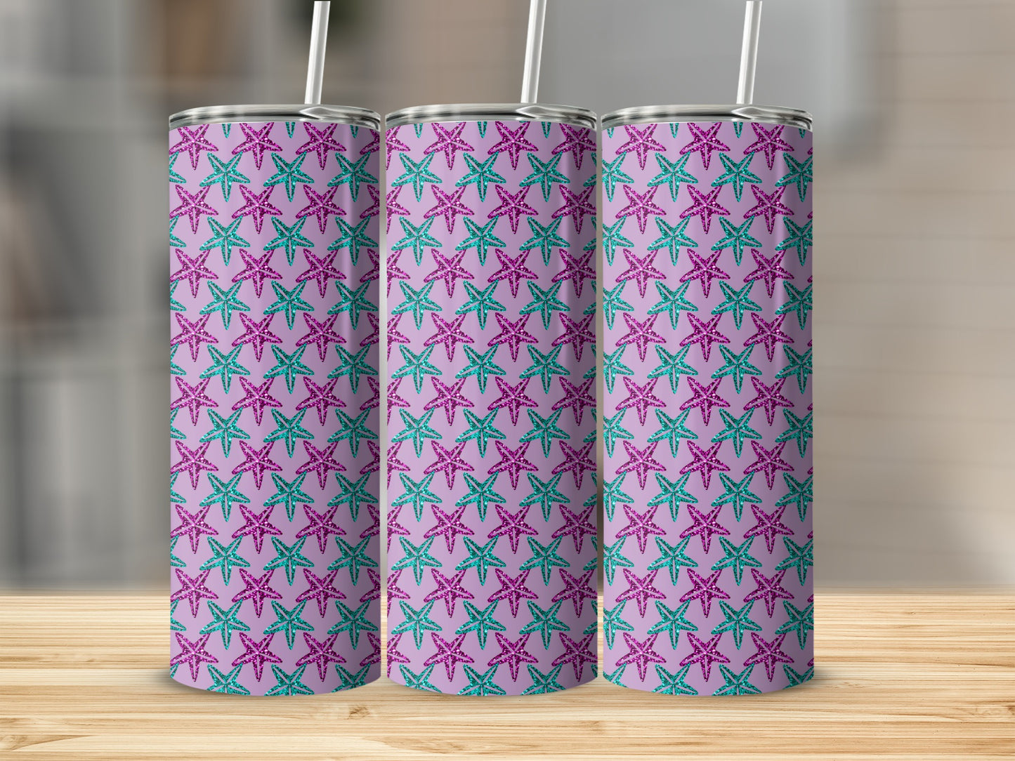 Three tumblers with a repeating pattern of glittery purple and teal starfish on a lavender background.