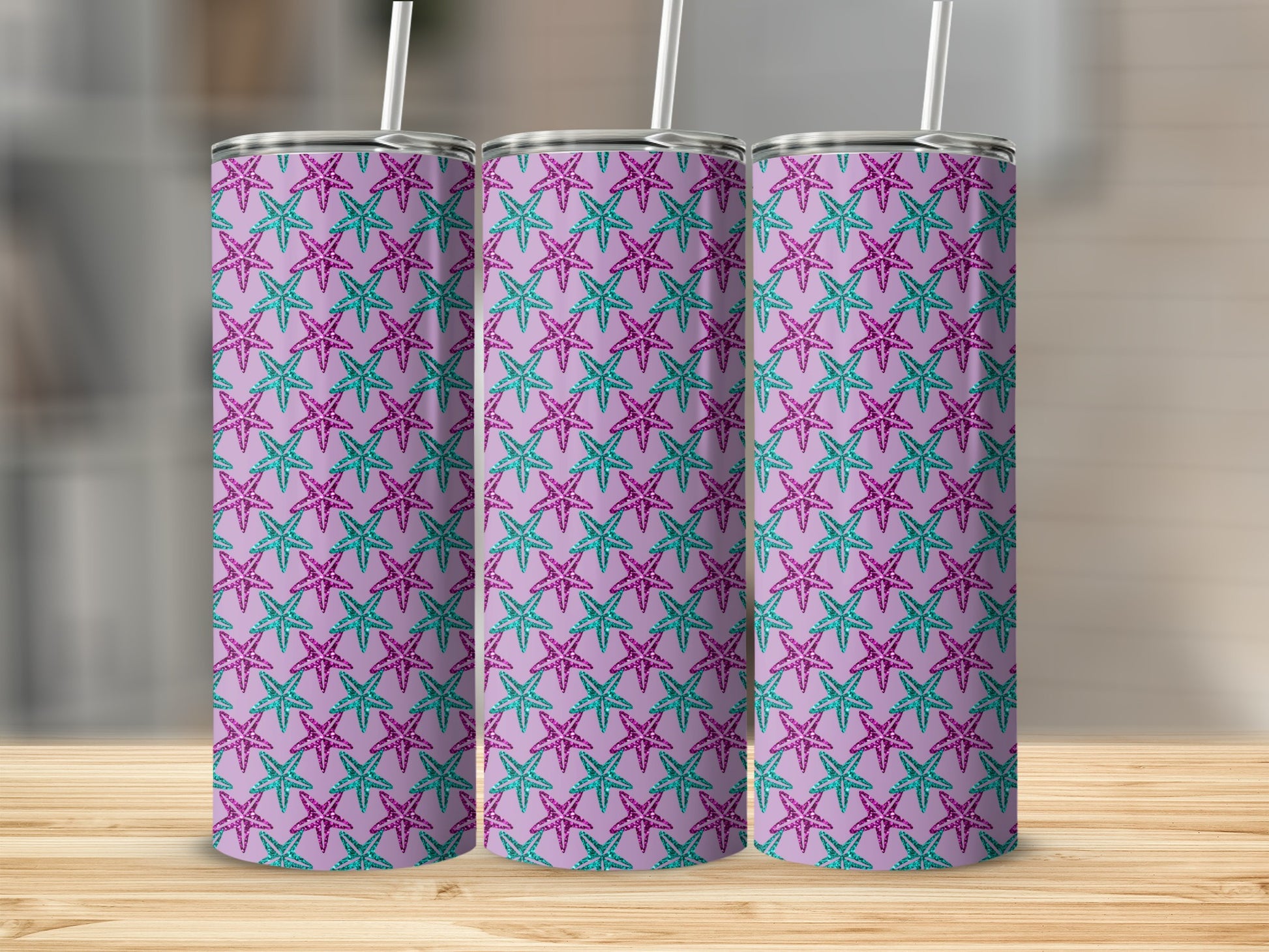 Three tumblers with a repeating pattern of glittery purple and teal starfish on a lavender background.