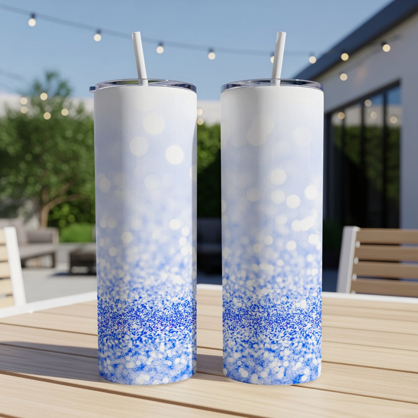 Two blue glitter tumblers with white straw and ombre glitter design.