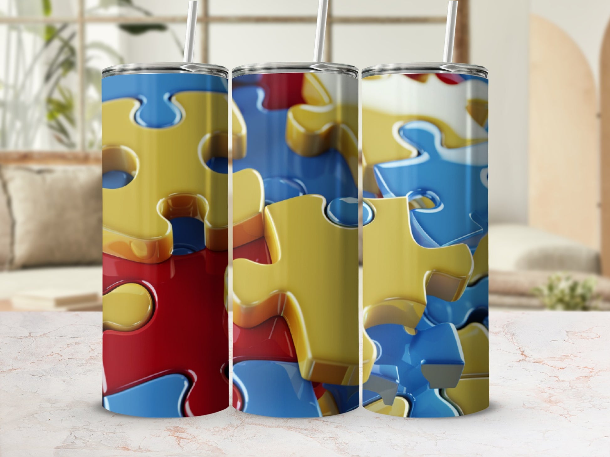 Three tumblers with a red, blue, and yellow puzzle piece pattern.