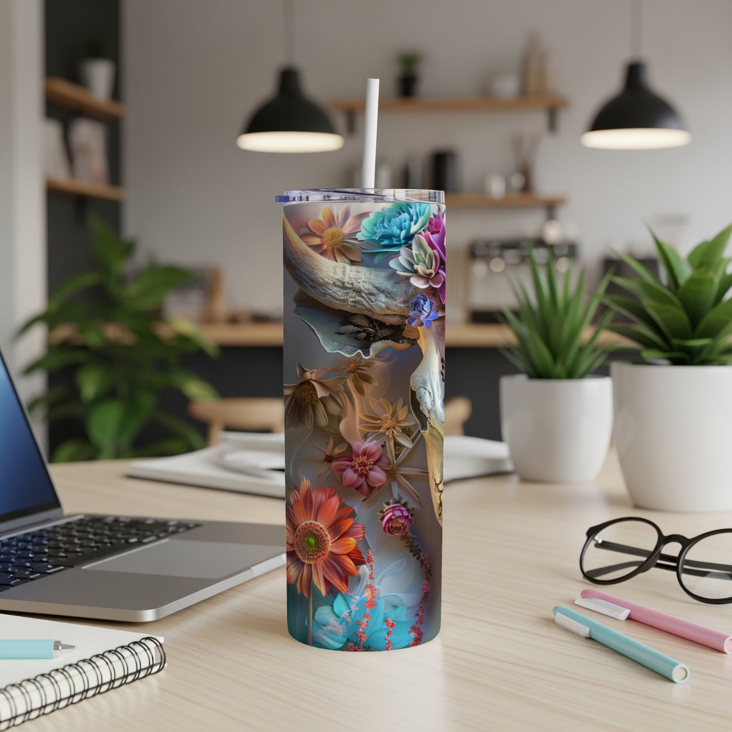 Tumbler with vibrant floral and natural design, on a desk.
