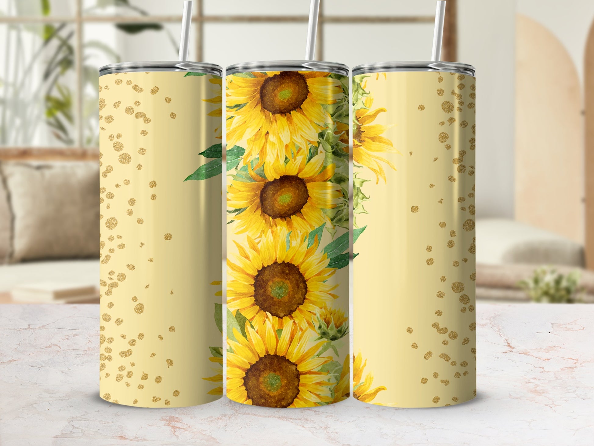 Three tumblers with a sunflower pattern and gold glitter accents.