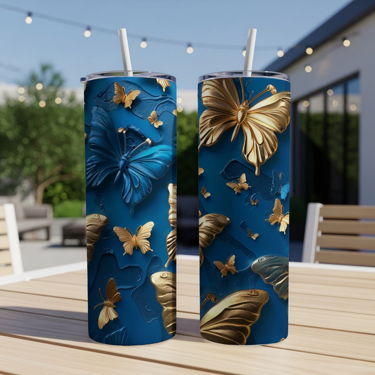 Blue tumbler with gold butterflies on a textured background.