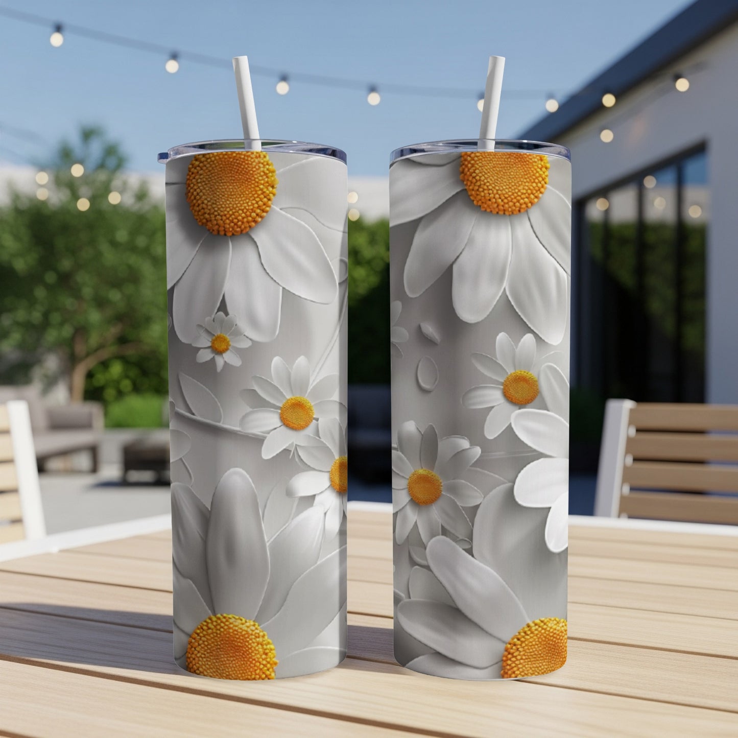 Two white tumblers with large, embossed daisy designs on a wooden table.