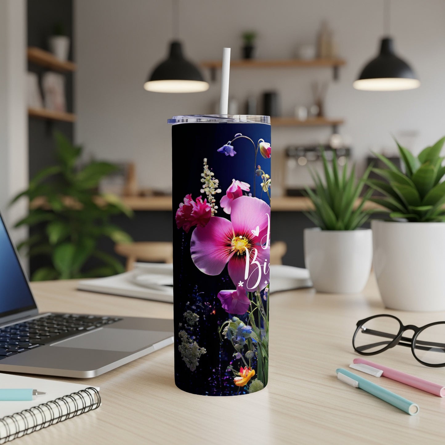 Tall, dark blue tumbler with pink floral design and "Just Breathe" text.