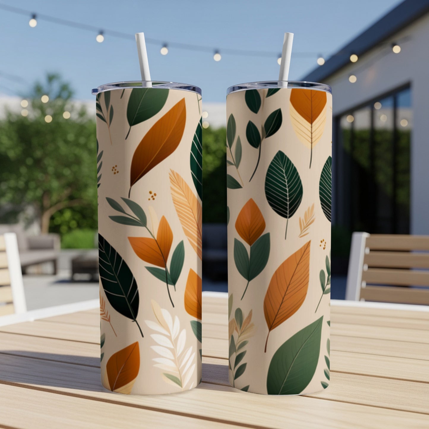 Two tumblers with a pattern of tan, orange, and green fall leaves.
