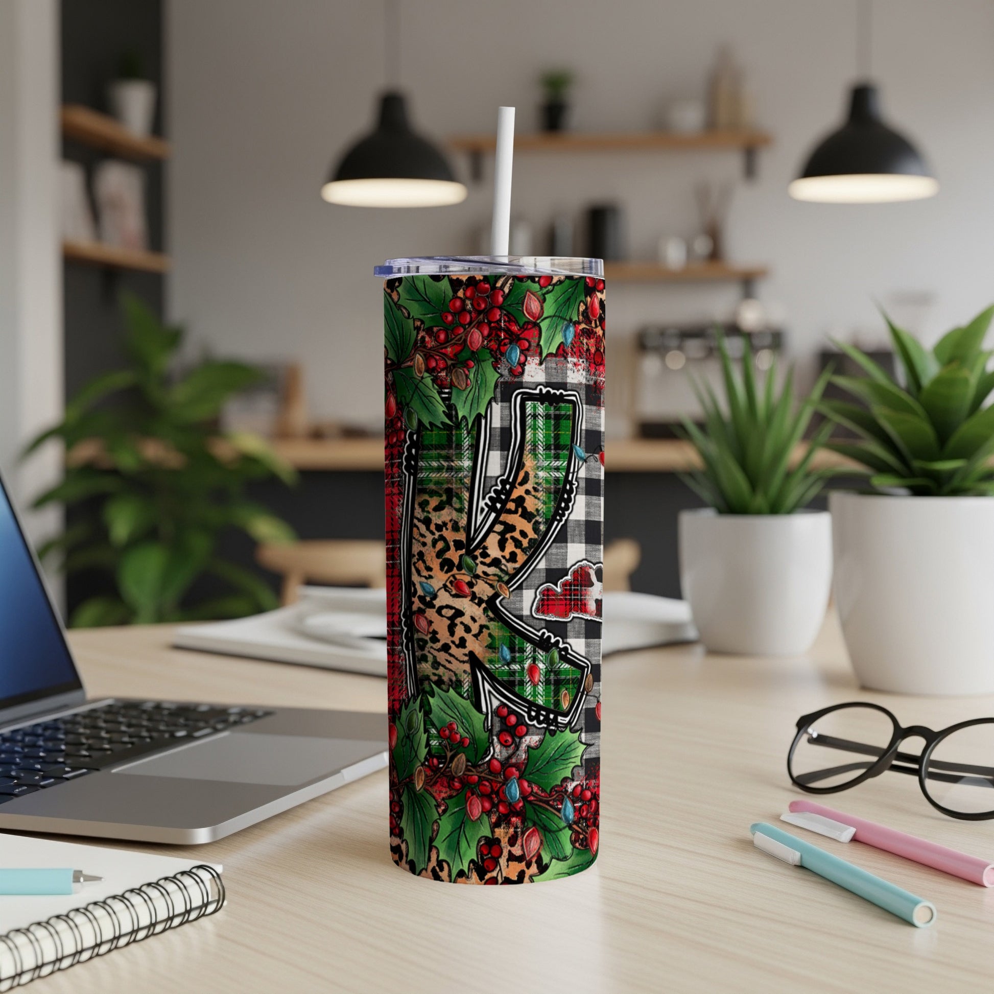 Tall tumbler with plaid and leopard print "K" and holiday lights.