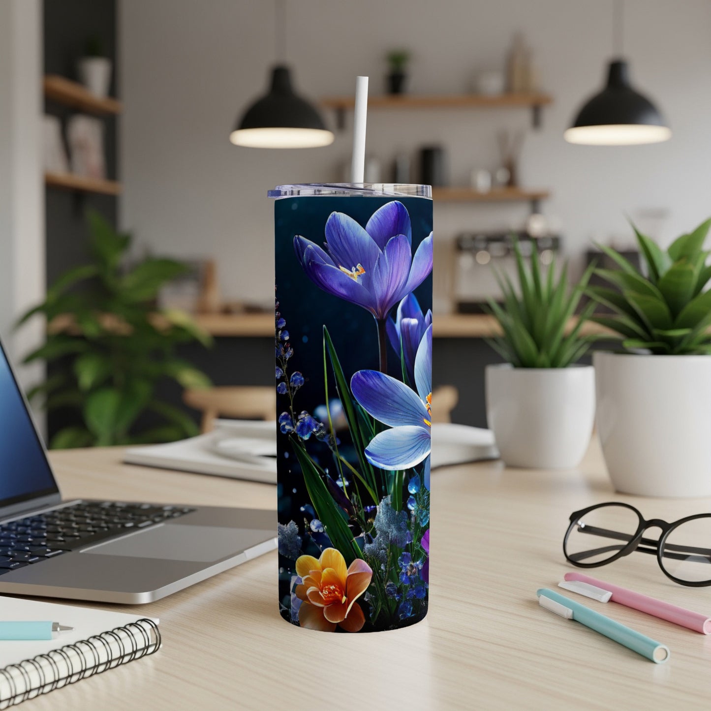 Purple and blue flowers on a dark background on a tumbler.