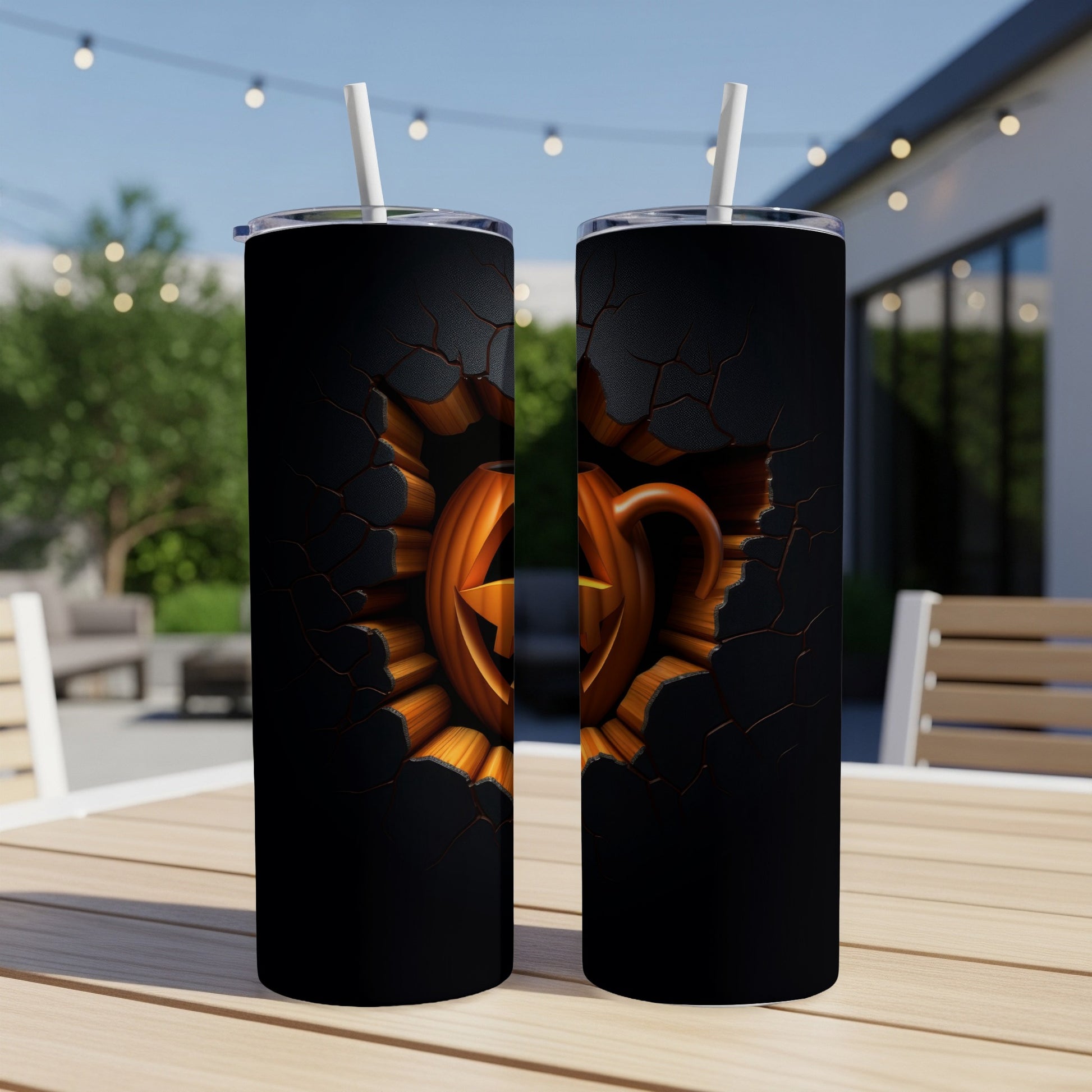Two tumblers with a cracked black surface revealing a carved jack-o'-lantern.