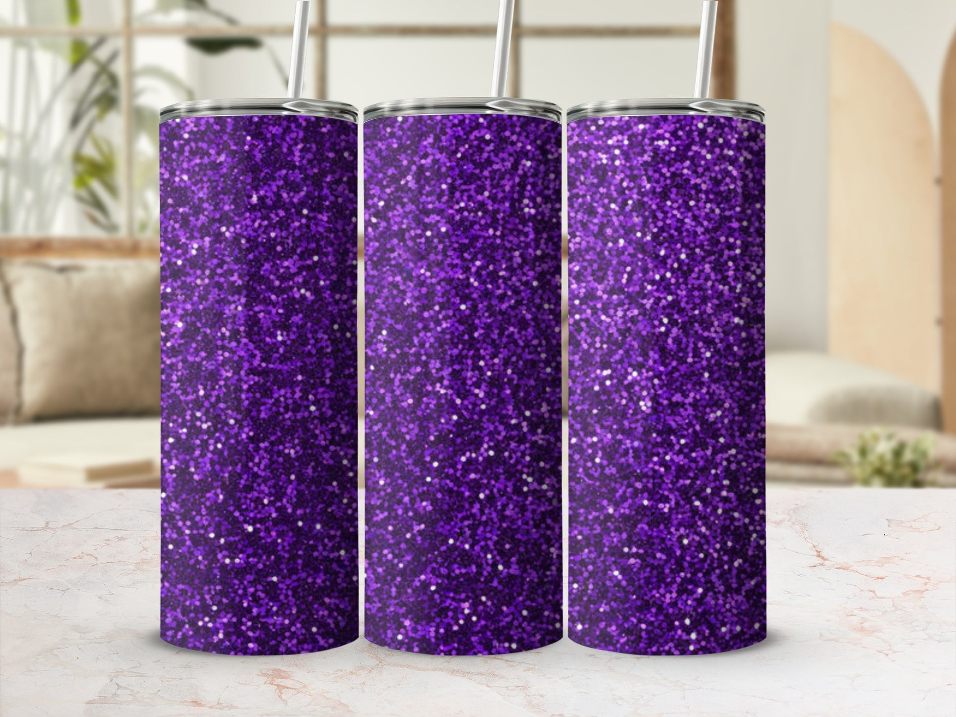 Three tall purple glitter tumblers with straws stand on a marble surface.